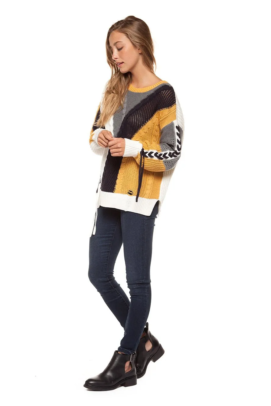 Long sleeve color block cable knit sweater with lace-up trim